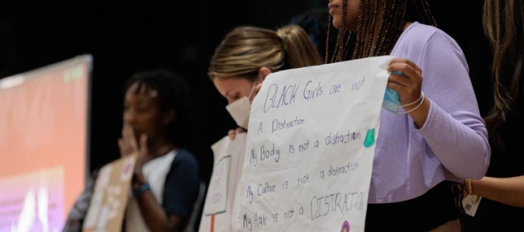 Students holding up signs