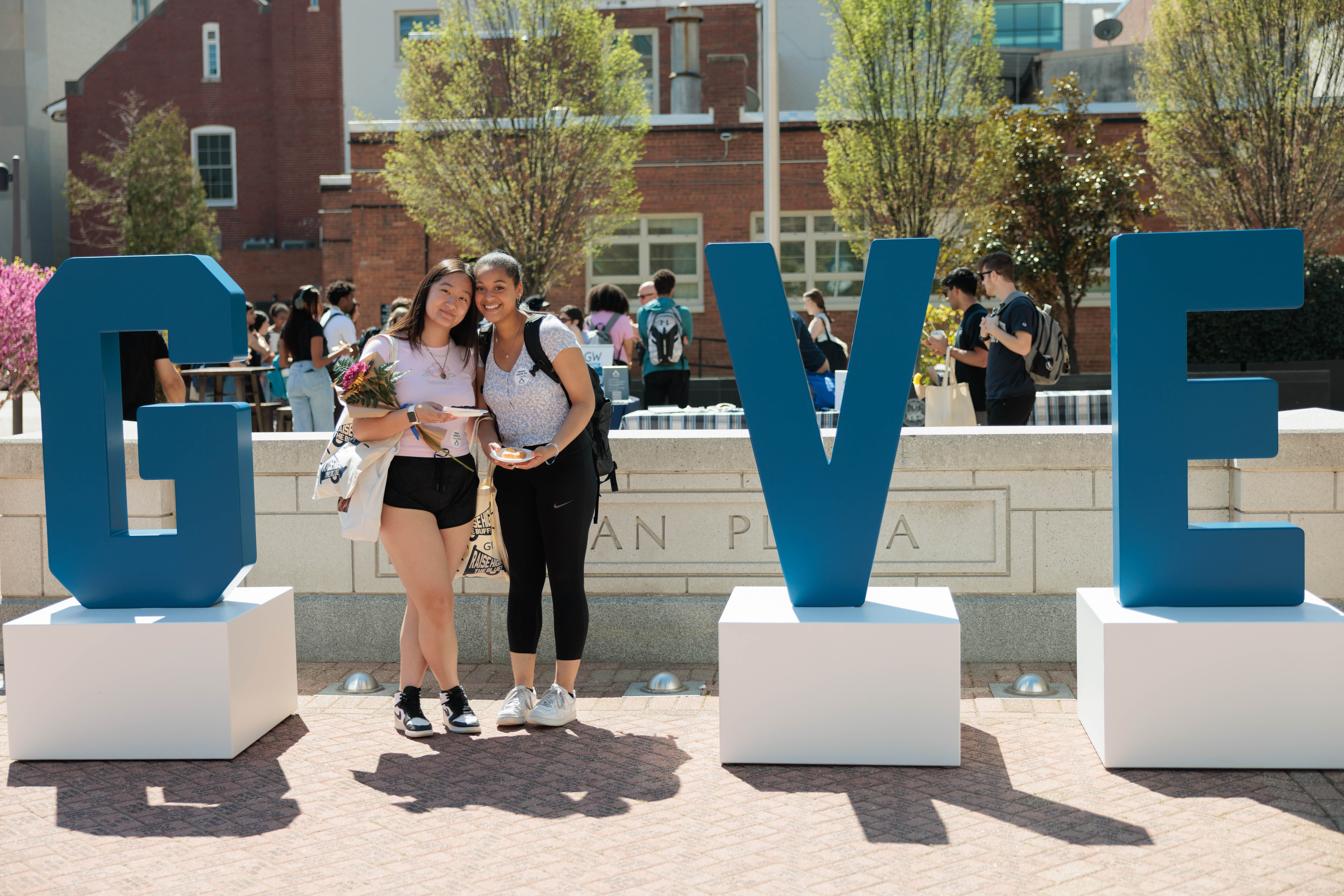 Students at Giving Day 2023 standing in an installation that spells the word GIVE.