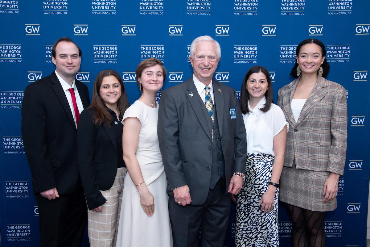 A group of people pose for a photo at the dinner.
