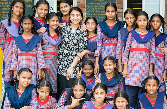 Gayatri Malhotra, Milken SPH ’19 (in flower print) with students at a government school in Punjab.