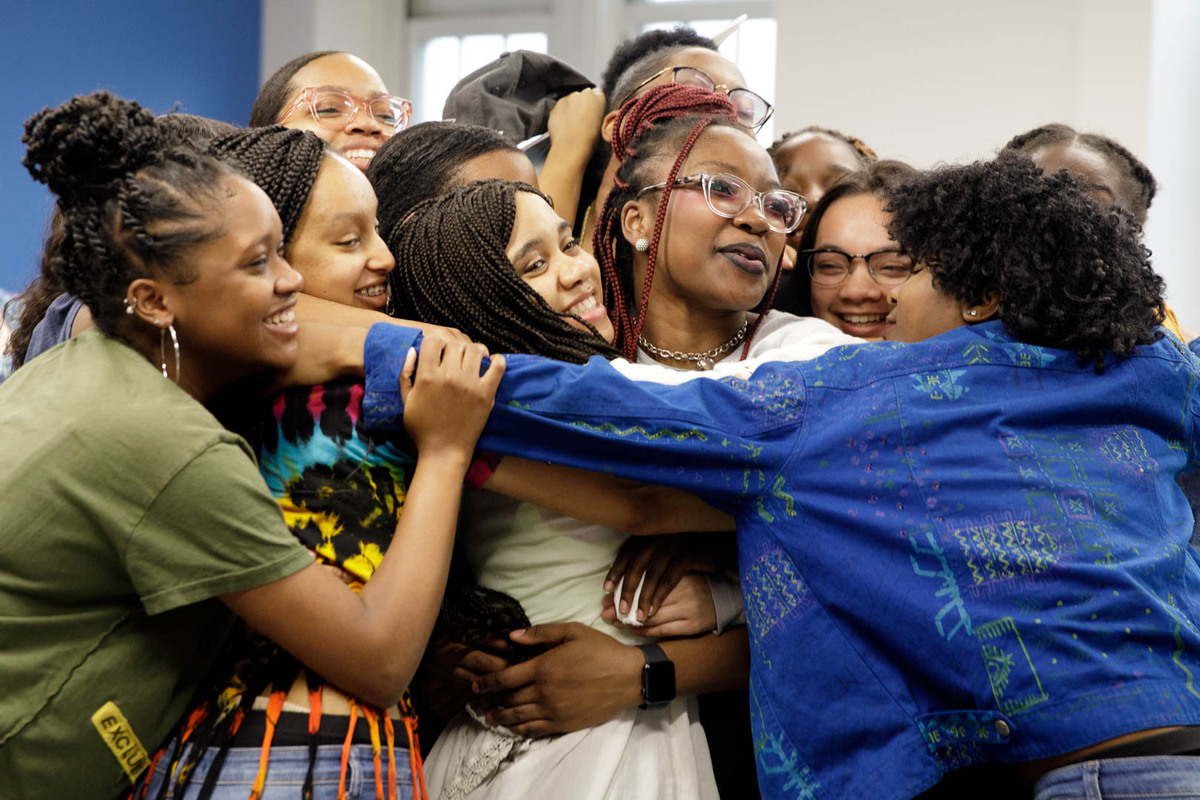 Classmates rushed to congratulate SJT winner Blyss Swan (center, in white with dark braids). (William Atkins/GW Today)