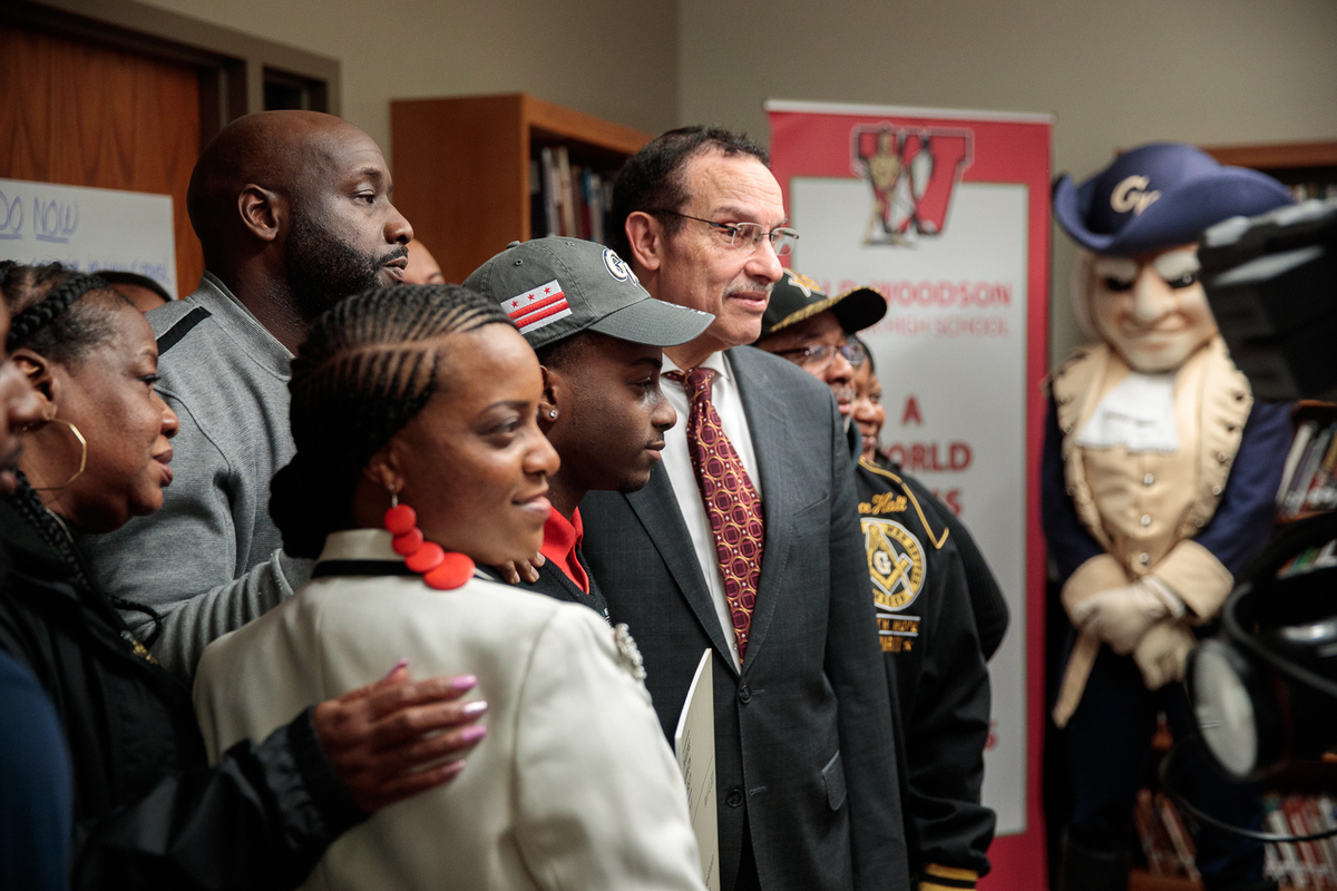 Councilmember Vincent Gray helped surprise winner Michael Prather at Woodson High School. (Harrison Jones/GW Today)
