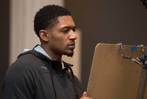 Corcoran student at an easel.