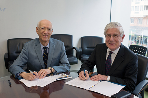 Reg Mitchell (left) and Dean Dolling sign scholarship agreement.