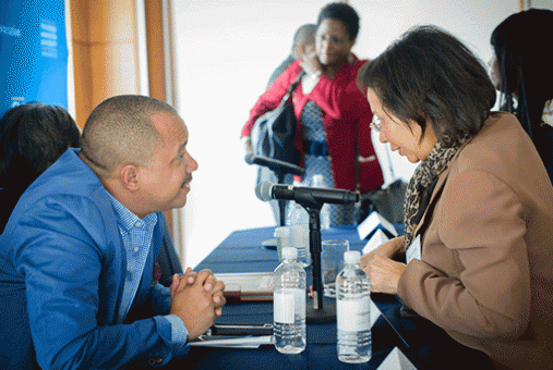 Council Members speak with alums at a GWBAA council meeting.