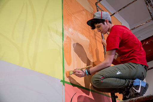 Corcoran student painting from a scaffold.